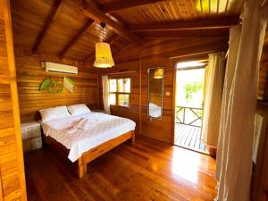 a bedroom with a bed in a wooden room at arzum bungalovs in Kumluca