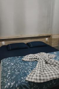 a bed with a blanket on top of it at Alojamento Pousada Economica Canoas in Canoas