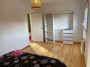 a bedroom with a bed and a closet with a refrigerator at Esprit Gare in Haubourdin