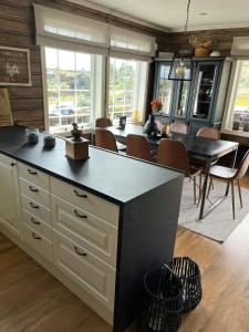 a kitchen with a table and a dining room at Mountain Cabin With Jacuzzi In Gautefall in Drangedal