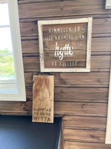 a sign on the wall of a building at Mountain Cabin With Jacuzzi In Gautefall in Drangedal +13 photos