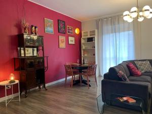 a living room with a couch and a table at Vespro 1 Apartment - near the Greek theater in Syracuse