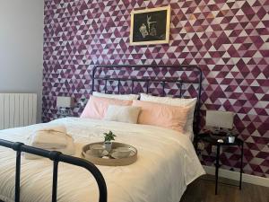 a bed with a tray on it in a bedroom at Vespro 1 Apartment - near the Greek theater in Syracuse