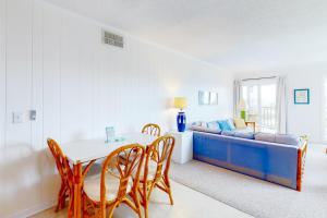 a living room with a table and a couch at ABSW163 Southwinds H13 in Atlantic Beach