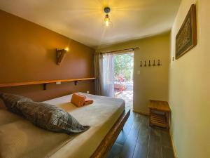a bedroom with a large bed with a window at Vientos - La Yareta in San Pedro de Atacama