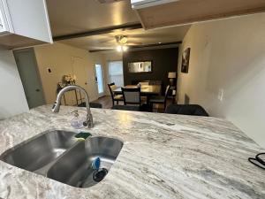 a kitchen with a sink and a living room at NEW Modern Retreat in Richardson