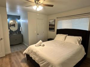 a bedroom with a large bed with a ceiling fan at NEW Modern Retreat in Richardson
