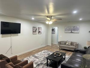 a living room with a couch and a flat screen tv at NEW Modern Retreat in Richardson