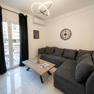 a living room with a couch and a table at White Port Suite in Ágios Rókkos