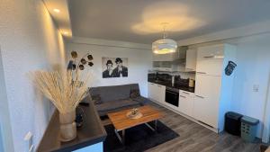 a living room with a table and a kitchen at Sweet Sleep Apartment in Burg Stargard