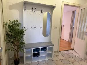 a dressing room with a mirror and a sink at Vina Ferienwohnung in Emden