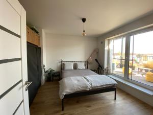 a bedroom with a bed and a large window at Apartment Nina in Hrubá Borša