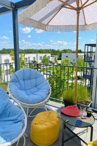 a patio with chairs and tables and an umbrella at Apartment Nina in Hrubá Borša +6 photos