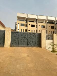 a black gate in front of a building at One bedroom apartment Presidential suite in Abuja