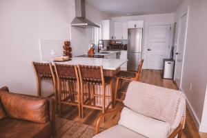 a kitchen with a table and chairs in a room at Modern Nordic Cabin 2 Hot Tub & Views in East LaHave