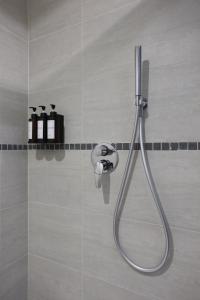 a shower with a hose in a bathroom at Sweet Home Fleming in Rome +43 photos