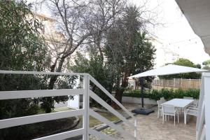 a white fence with a table and an umbrella at Sweet Home Fleming in Rome