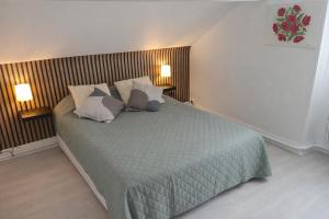 a bedroom with a bed with two pillows on it at Lycot in Dompierre-Becquincourt