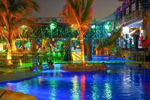 a water park with people in a pool at night at Laguna Beach Ecohotel in Tolú +5 photos