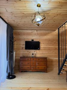 a room with a television and a wooden wall at Sno loveland in Sno