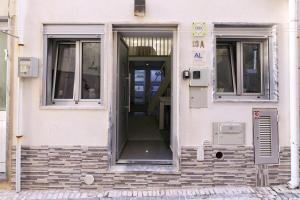 an open door of a building with a staircase at Dina Beach House in Nazaré