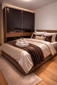 a bedroom with a large bed with a large window at Avenoir Suite in Banja Luka