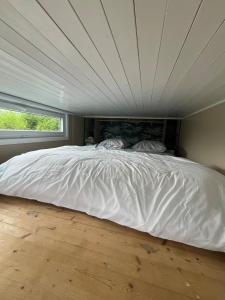 a bed in a bedroom with a large white comforter at Le repère d Howardries in Brunehaut