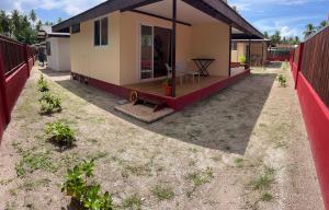 a small house with a patio and a fence at Hiti Village G4 in Tikehau Airport