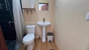 a small bathroom with a toilet and a sink at Hiti Village G4 in Tikehau Airport