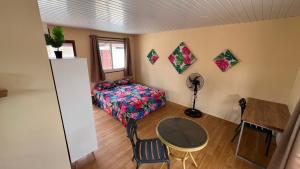 a small room with a bed and a table at Hiti Village G4 in Tikehau Airport