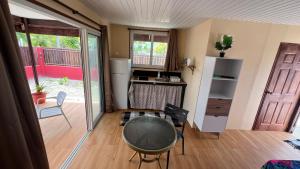 a kitchen with a table and chairs in a room at Hiti Village G4 in Tikehau Airport