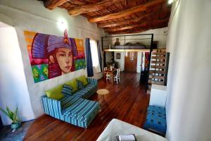 a living room with a couch and a painting on the wall at Vientos - La Yareta in San Pedro de Atacama