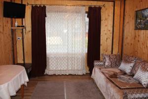 a living room with a couch and a window at U Bogdana in Yaremche