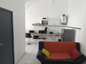 a living room with a couch and a kitchen at TRANSIT AFFAIRES - LOISIRS in Pointe-à-Pitre
