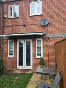 a brick house with a table in front of it at PR 2 BR Modern Home in Middlesbrough