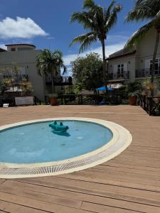 a swimming pool with a toy in the middle at Charming poolside condo in Cap Cove in Cap Estate