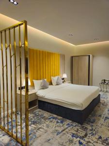 a hotel room with a bed and a staircase at Al Seef Hotel in Al-ʿUla