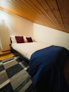 a bedroom with a bed with a wooden ceiling at Chiasso Swiss Apartment by RentuGoo Travel in Chiasso
