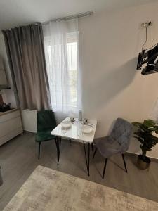 a living room with a white table and two chairs at EriSSSo House Murfatlar in Murfatlar +5 photos