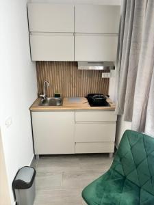 a small kitchen with a sink and a chair at EriSSSo House Murfatlar in Murfatlar