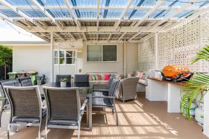 an outdoor patio with a table and chairs at Kaimana in Gold Coast