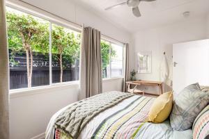 a bedroom with a bed and a window at Kaimana in Gold Coast