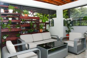 a patio with chairs and a table and some plants at Fahari Cedar House in Kericho