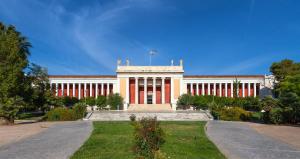 a large building with red and white columns at INOH Athens Hotel in Athens