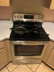 a stove with two pots on top of it at The Relaxing Home in Memphis