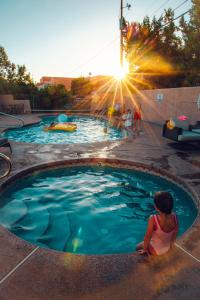 a little girl sitting in a swimming pool at Sugar Loaf Lodge in Sedona