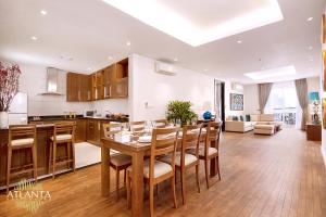 a kitchen and dining room with a table and chairs at Atlanta Residences in Hanoi