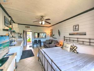 a bedroom with a bed and a living room at Pirates Bay B114 in Fort Walton Beach