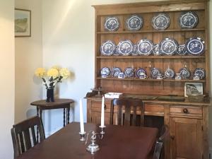 a dining room with a table and plates on a wall at Hazeldene in Bishopston