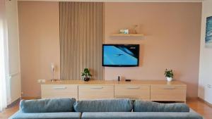 a living room with a couch and a flat screen tv at Apartment Sarah in Čavle